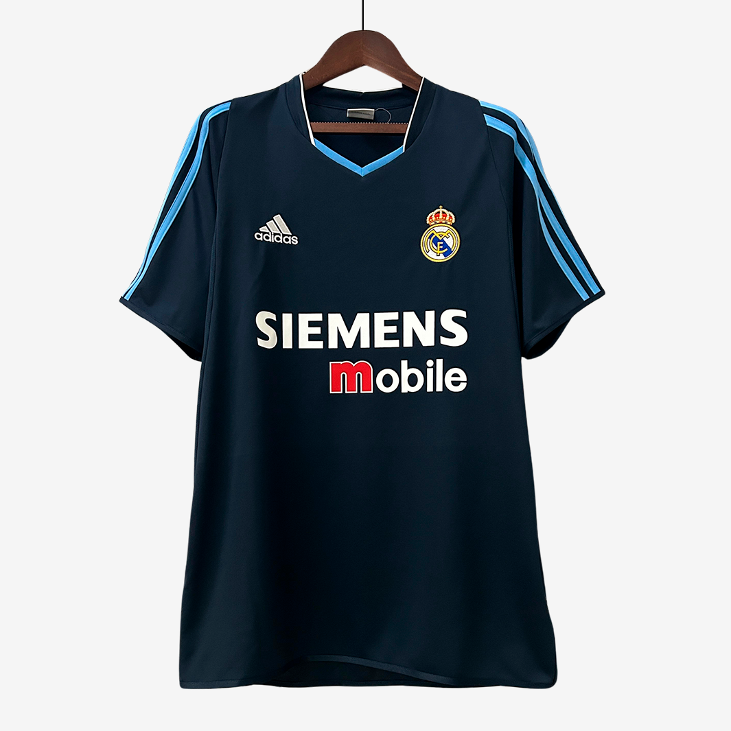 6-125_2269c8e8-7eb3-482d-913c-3cc7d2b7391b Real Madrid 2003/04 Away Jersey – Retro Version - Image 1